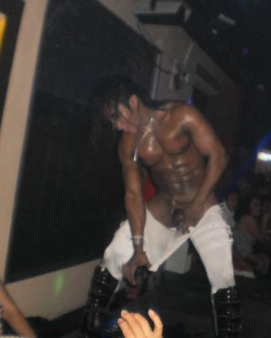 A Latino male stripper showing his penis