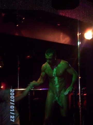 A real male stripper from the UK dances naked during a ladies night